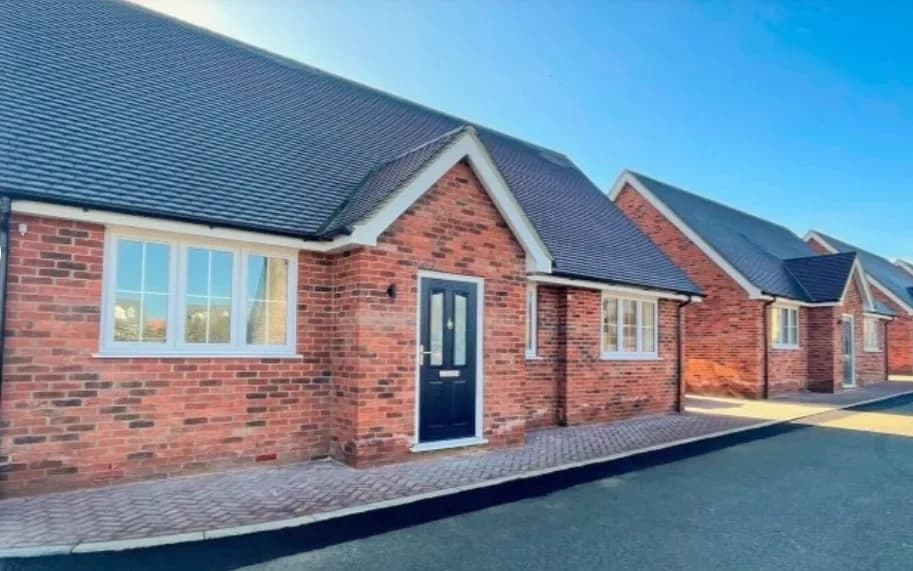 A row of newbuild brick bungalows at Martello Drive, Walton on the Naze